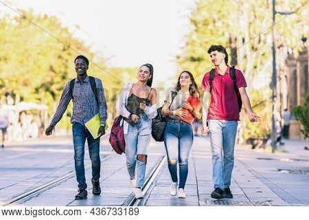 Group Of Friends Of Different Ethnicities Walking In A Pedestrian Street