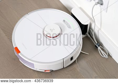 Tallinn, Estonia - October 10, 2021: Xiomi S7 Roborock Vacuum Cleaner On Charging Dock Station. Clos