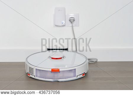 Tallinn, Estonia - October 10, 2021: Xiomi S7 Roborock Vacuum Cleaner On Charging Dock Station. Clos