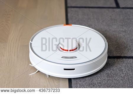 Robot Vacuum Cleaner Performs Automatic Cleaning Of The Apartment With Carpet And Laminate Floors Cl
