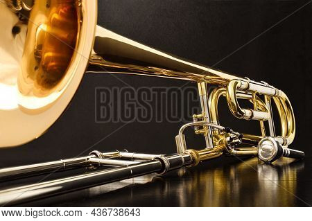 Trombone With Transposer Mounted On A White Table. Front View. Horizontal Composition.