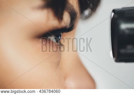 Ophthalmologist Doctor Woman Looking At Eyepiece. Ophthalmology. Close-up, Horizontally.
