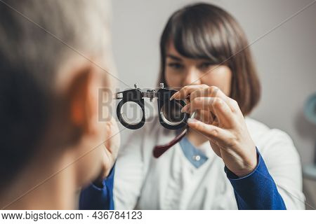 Optometrist Picks Up Glasses For Correction Of Myopia Man. Concept Of Visual Impairment In Adults. V