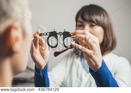 Optometrist Picks Up Glasses To Correct Astigmatism Guy. Concept Of Visual Impairment In Adults. Vis