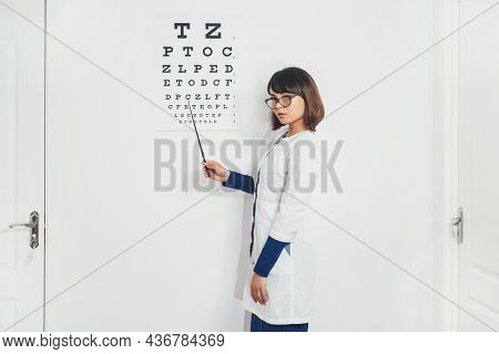 Doctor Ophthalmologist Next To Machine To Check View. Hospital, Clinic, Examination. Vision Tests At