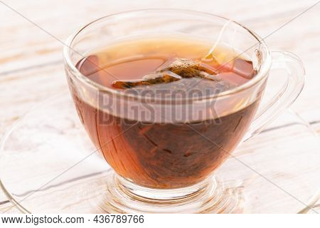 Steeping A Herbal Tea Bag In A Glass Cup Close Up