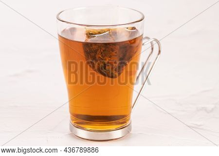 Steeping A Herbal Tea Bag In A Glass Tea Mug Close Up