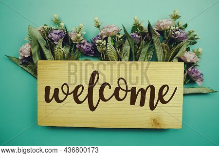 Welcome Sign With Flowers Frame Decprate On Blue Background