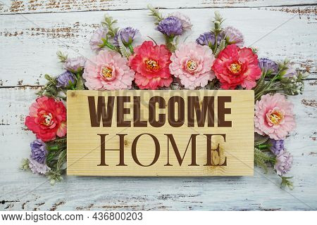 Welcome Home Text With Flowers Frame Decprate On Wooden Background