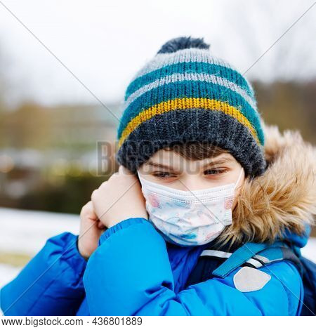 Kid Boy Wearing Ffp Medical Mask On The Way To School. Child Backpack Satchel. Schoolkid On Cold Aut