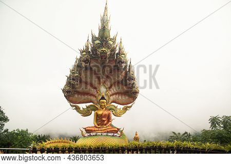 Sakon Nakhon,thailand - October 1 , 2020 : A Large Golden Seated Buddha Statue Outdoors, Sheltered B