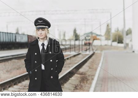 European Or American Train Conductor Is On His Duty On A Platform And Other Trains. Railway, Steam T