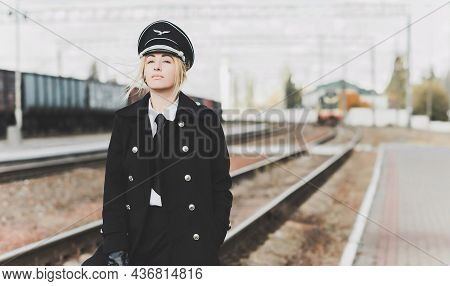 European Or American Train Conductor Is On His Duty On A Platform And Other Trains. Railway, Steam T