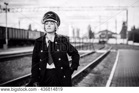 European Or American Train Conductor Is On His Duty On A Platform And Other Trains. Railway, Steam T