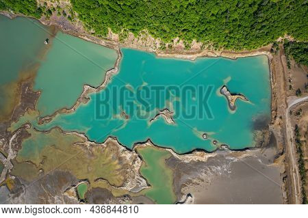Drone View Of The Turquoise Lake Formed As A Result Of Mining Waste