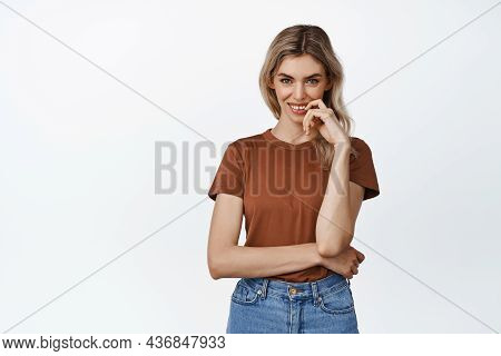 Flirty Blond Girl Looking At Amera With Smiling Cunning Face Expression, Has An Idea, Standing Again