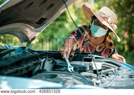 An Old Woman Standing At A Broken Car Trying To Fix The Car Senior Woman The Car Is Broken Road And 