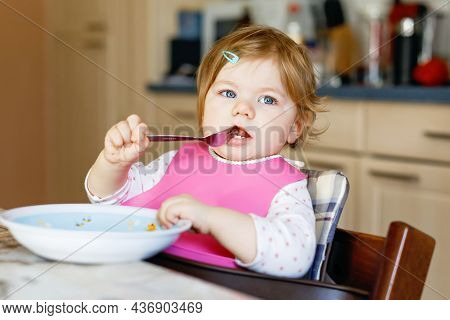 Adorable Baby Girl Eating From Spoon Mashed Vegetables And Puree. Food, Child, Feeding And People Co