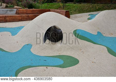 Dreamy White Rubber Landscape With Scoops And Colorful Spots On The Playground. Stainless Steel Tunn