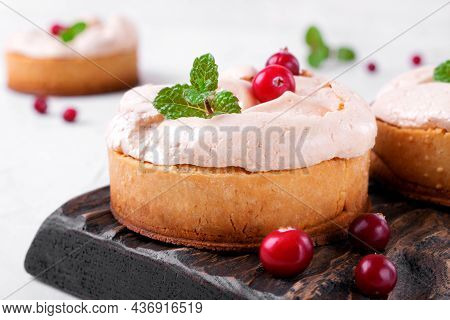 Small Meringue Pie With Fruit And Berry Curd On Shortcrust Pastry Served On The Wooden Board. Portio