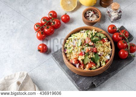 Salad With Bulgur, Tomatoes, Cucumbers And Parsley. Tabouleh Dish. Oriental Cuisine. Copy Space.