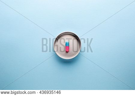Multi-colored Pills. Five Tablets. Pink And Blue Pills On A Light Blue Background. Different Pills A