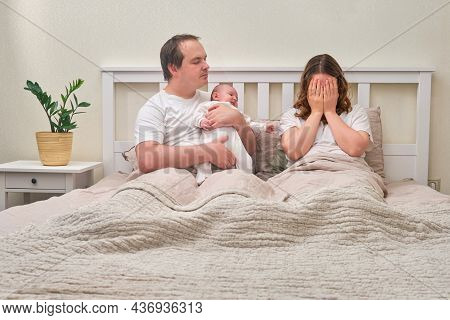 A Father With A Baby Boy And A Mother Crying In Postpartum Depression, Parents And An Infant Child O