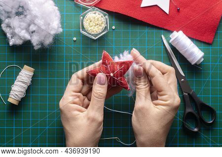 Filling The Felt Christmas Star With Holofiber. Step-by-step Manufacturing Instructions. Step 8.