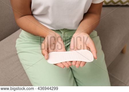 Young Woman With Pantyliner On Sofa, Closeup