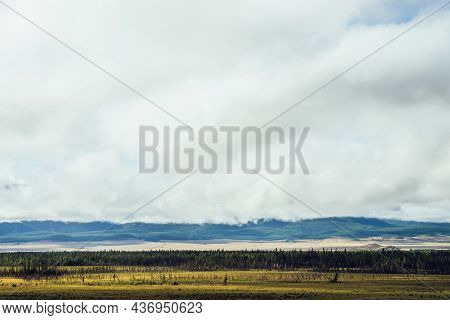 Beautiful Layered Landscape With Hills And Forest In Mountain Valley And Low Clouds In Cloudy Sky. L