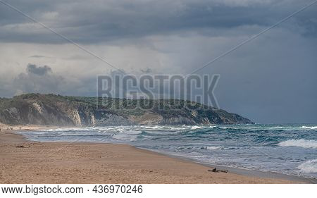 Beautiful Sandy Ocean Beach With Large Rocks On Shore And In Water. Powerful Waves On Ocean. Ocean W