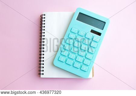 Mint Calculator And Notebook Isolated On Pink Background. Concept Of Family Budget And Payment Of Ta
