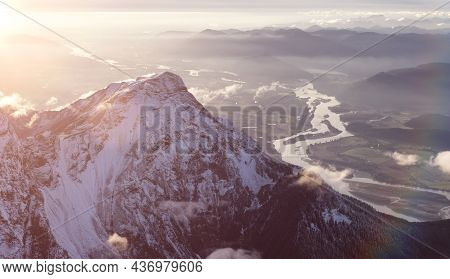 Aerial View Of Canadian Rocky Mountains With Snow On Top During Fall Season Sunset. Nature Landscape