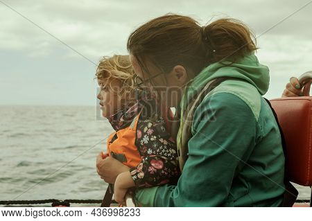 Mother And Daughter On A Boat Trip Observing The Sea And Enjoying The Ride.