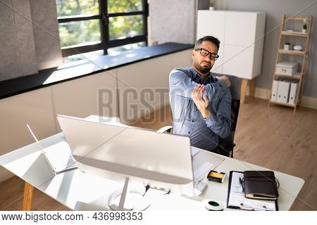 Shoulder Pain And Posture. Man Suffering Near Workstation Computer