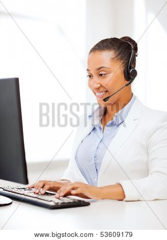 business, office and communication concept - african female helpline operator with headphones