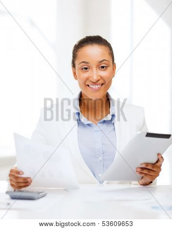 office, business, technology and internet concept - businesswoman with tablet pc in office
