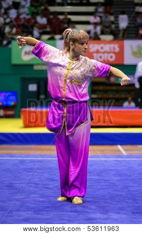 KUALA LUMPUR - NOV 03: Paula AS de Azevedo of Brazil shows her fighting style in the 'changquan compulsory' event at the 12th World Wushu Championship on November 03, 2013 in Kuala Lumpur, Malaysia.