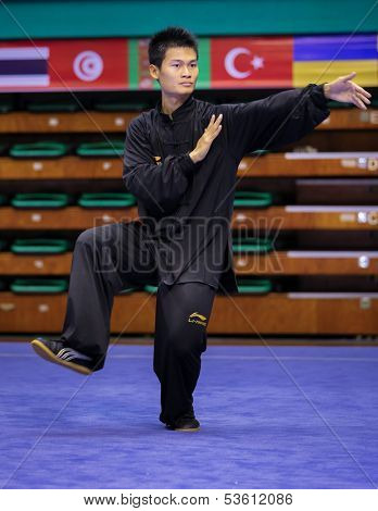 KUALA LUMPUR - NOV 03: Loh Jack Chang of Malaysia shows his fighting style in the 'Taiji quan' event at the 12th World Wushu Championship on November 03, 2013 in Kuala Lumpur, Malaysia.