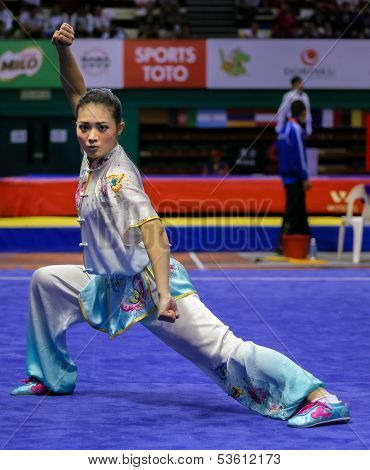 KUALA LUMPUR - NOV 03: Phoon Eyin of Malaysia shows her fighting style in the 'changquan compulsory' event at the 12th World Wushu Championship on November 03, 2013 in Kuala Lumpur, Malaysia.