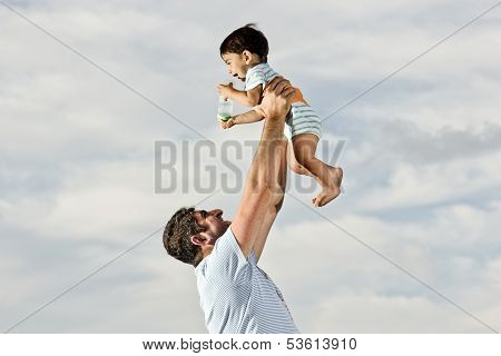Happy Dad With Baby At The Beach
