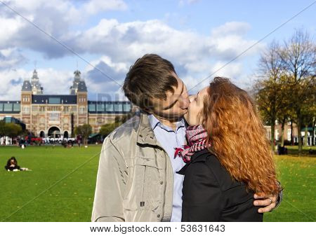 Outdoor Happy Couple Kissing In Museumplein, Amsterdam