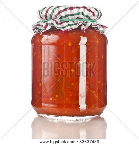 delicious product of roasted red pepper, tomatoes  in glass jar close up isolated on a white background 