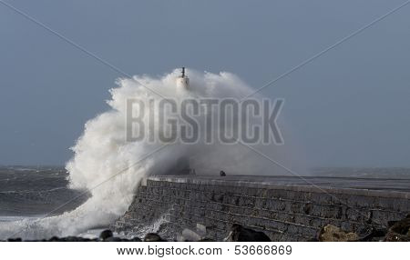 Big wave over lighthouse