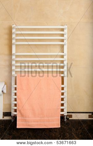 Color towel on  radiator in bathroom