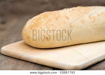 Loaf Of Sourdough Bread In Rustic Kitchend Setting