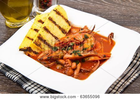 Fish Soup With Grilled Polenta On White Dish