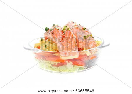 fresh fried natural pink salmon on italian traditional tagliatelle backed with tomato and vegetables isolated over white background