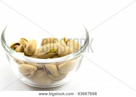 Pistachios In A Glass Plate, Isolated On White Background