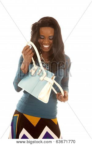 African American Woman Blue Top Look In Purse